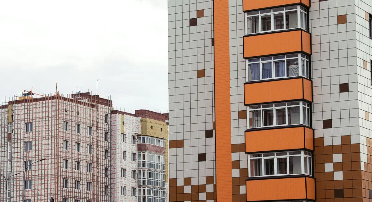 Close-up of modern high-rise apartment buildings with patterned facades.