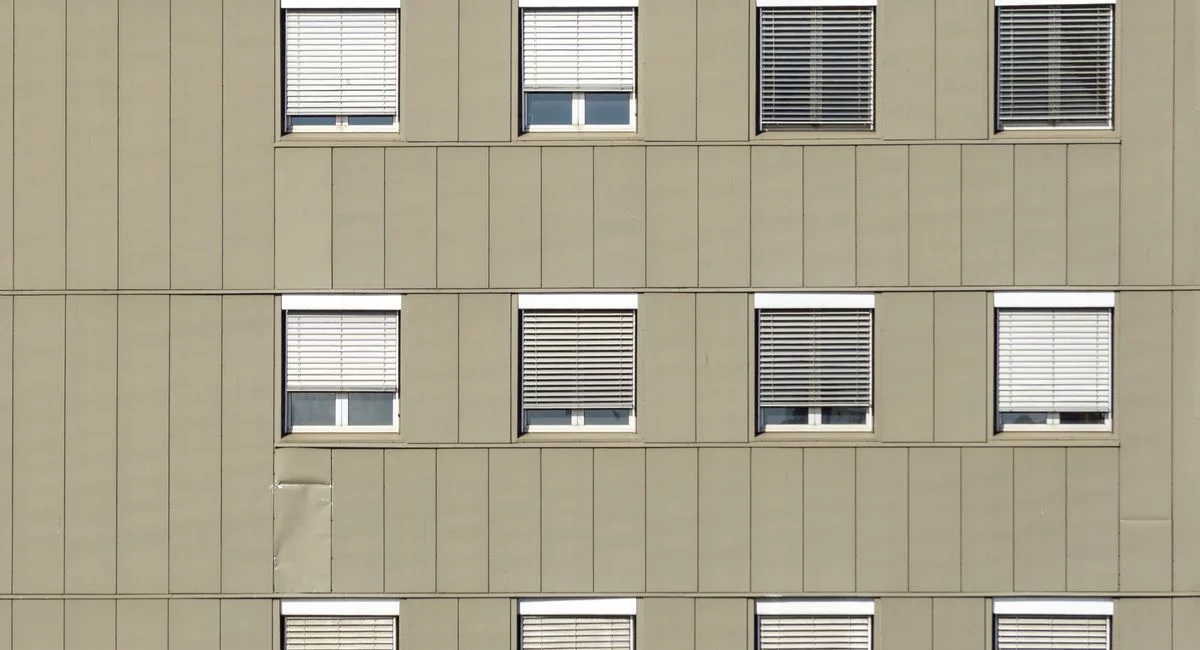 Modern apartment exterior in Oslo with geometric design and uniform windows.