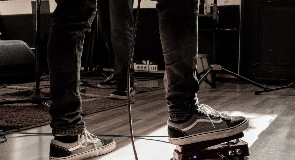 Live performance setup with musician using a guitar effects pedal in Uruguay.