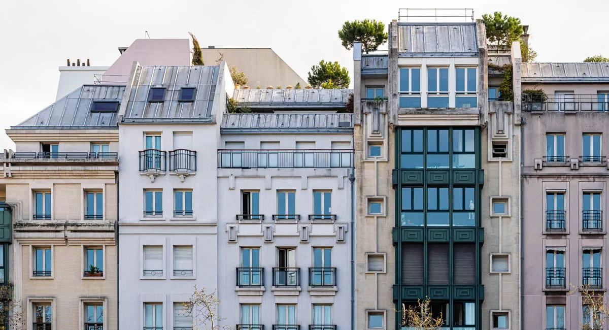 A picturesque view of a classic Parisian building facade with balconies and windows.