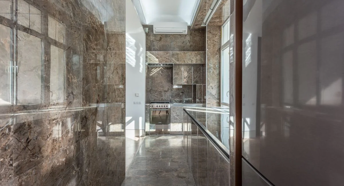 Sleek and elegant marble kitchen interior showcasing modern design with high-end finishes.