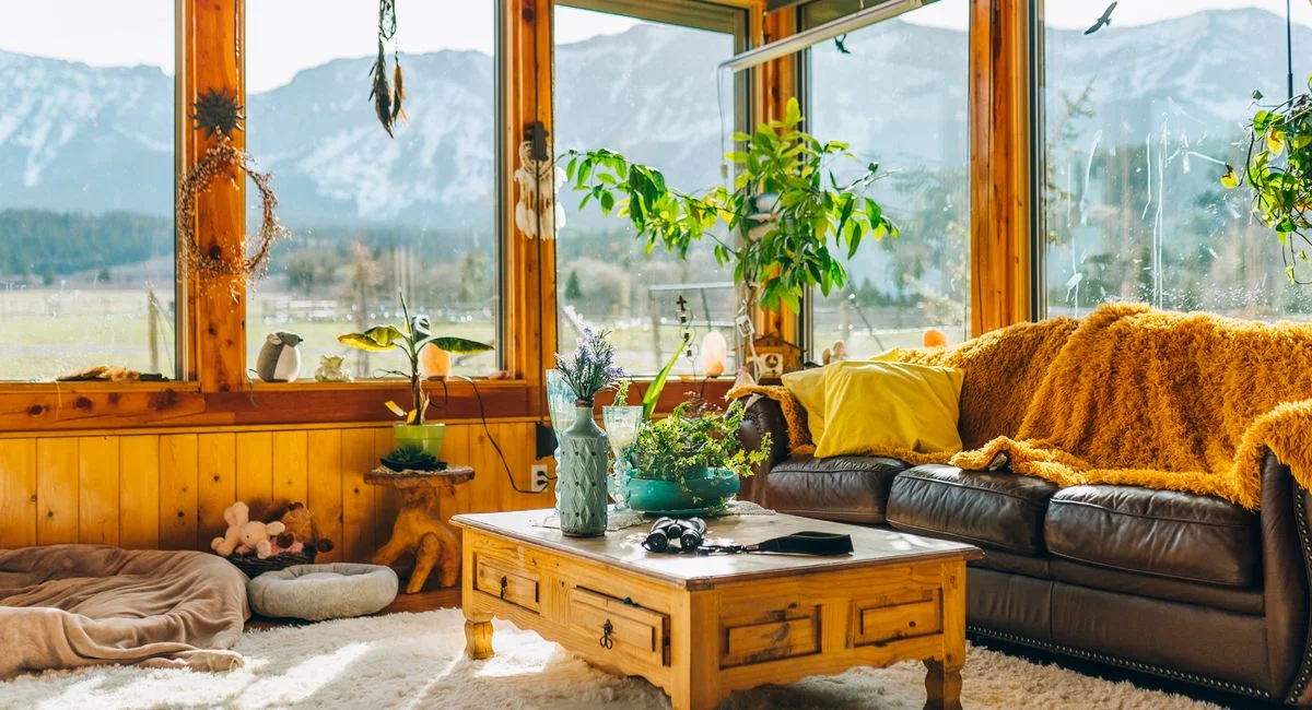 Warm and inviting interior living room with stunning mountain views through large windows.