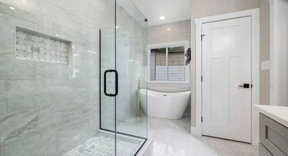 Bright modern bathroom featuring a glass shower and freestanding bathtub. Perfect for design inspiration.